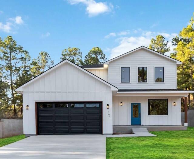 modern farmhouse style home featuring a garage and a front lawn