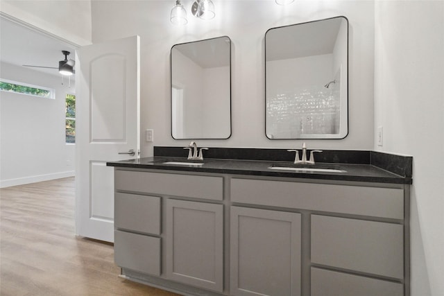 bathroom with vanity, hardwood / wood-style floors, ceiling fan, and walk in shower