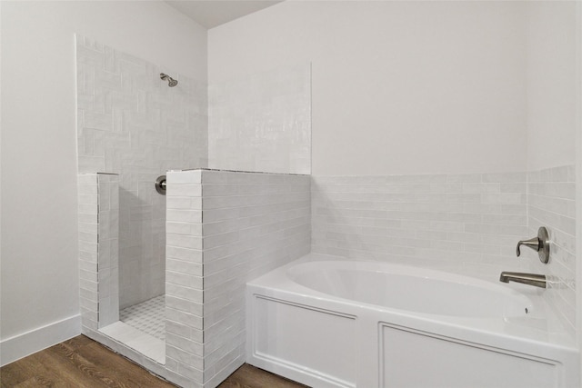 bathroom featuring hardwood / wood-style flooring and separate shower and tub