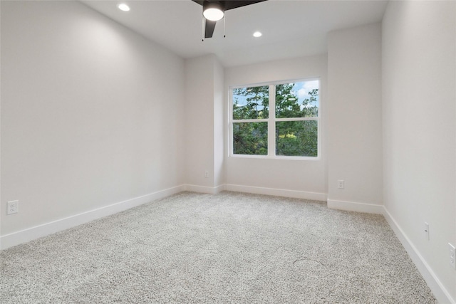 carpeted spare room with ceiling fan