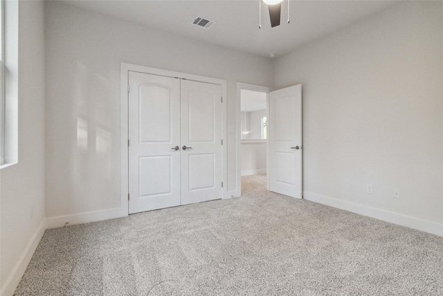 unfurnished bedroom featuring ceiling fan, carpet floors, and a closet