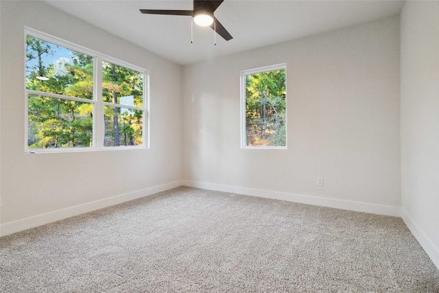 carpeted empty room featuring ceiling fan