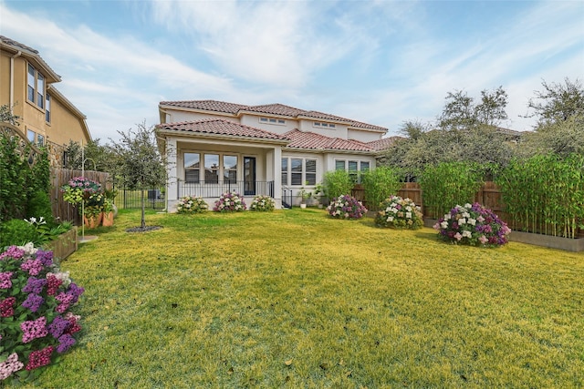 back of house with a porch and a lawn