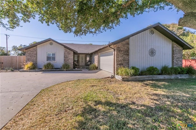 single story home featuring a front lawn and a garage