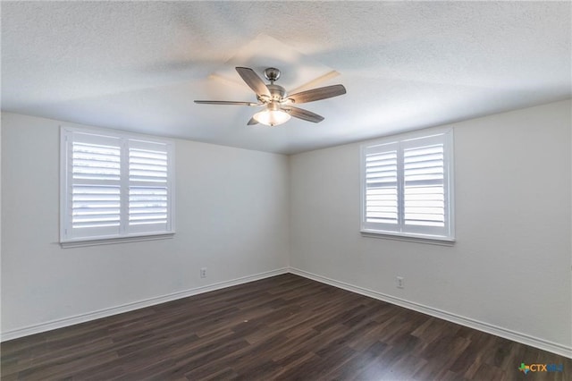 empty room featuring a textured ceiling, dark hardwood / wood-style floors, and ceiling fan