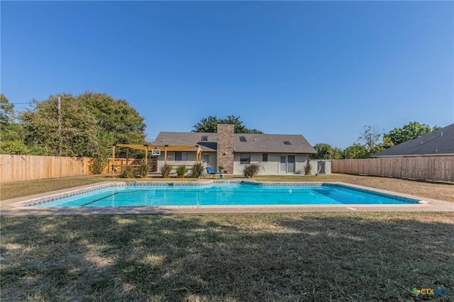 view of pool with a lawn