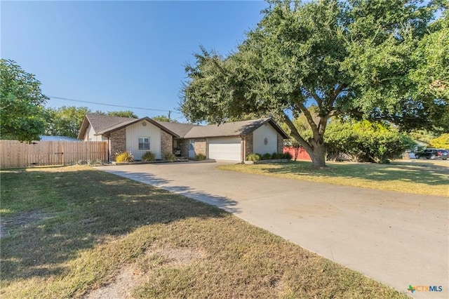 ranch-style home featuring a garage and a front yard