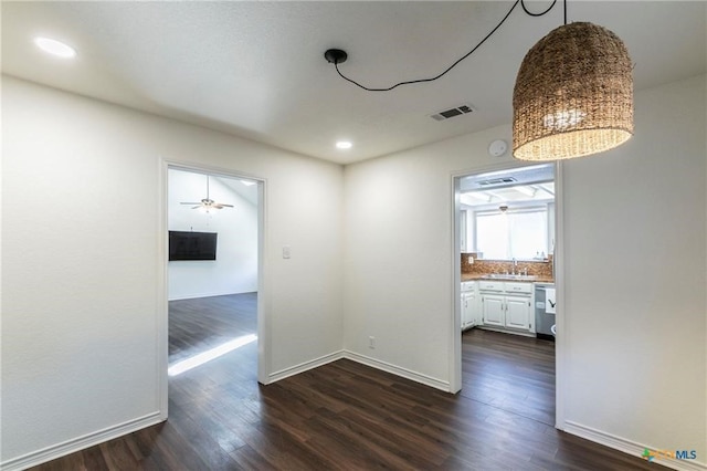 interior space with ceiling fan, dark hardwood / wood-style floors, and sink