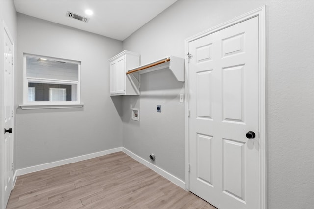 laundry area with cabinets, light hardwood / wood-style floors, electric dryer hookup, and washer hookup