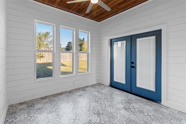 unfurnished sunroom featuring french doors, ceiling fan, and wood ceiling