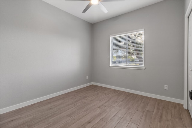 empty room with ceiling fan and light hardwood / wood-style flooring