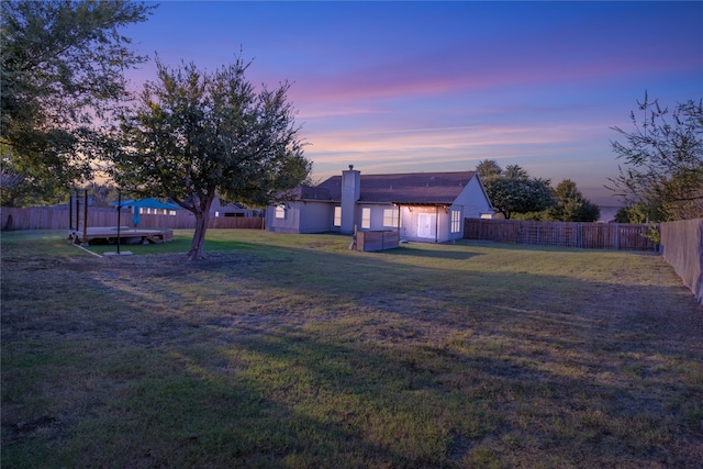 yard at dusk with a trampoline