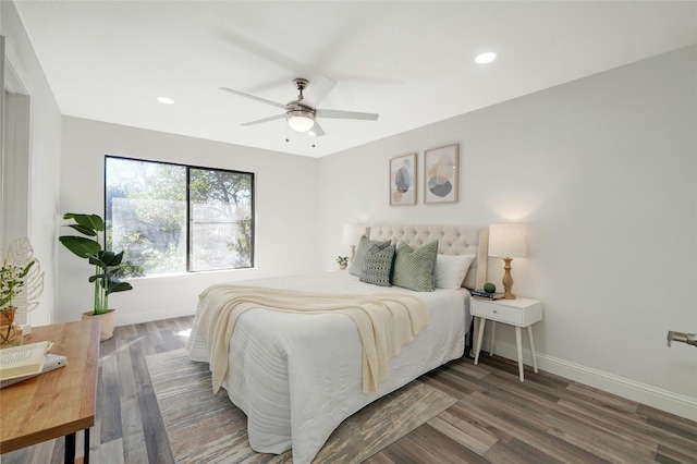 bedroom with dark hardwood / wood-style flooring and ceiling fan