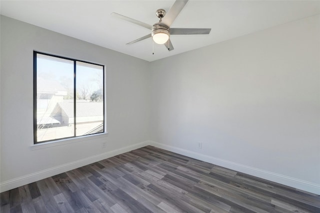 spare room with dark hardwood / wood-style flooring and ceiling fan