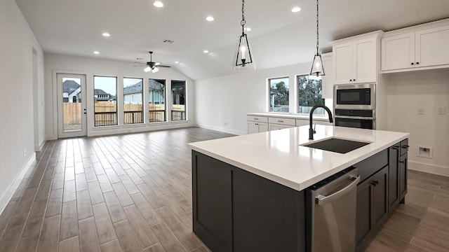 kitchen featuring stainless steel appliances, plenty of natural light, a sink, and white cabinetry