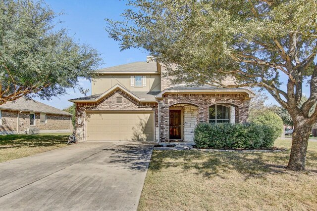 view of front facade with a garage and a front yard