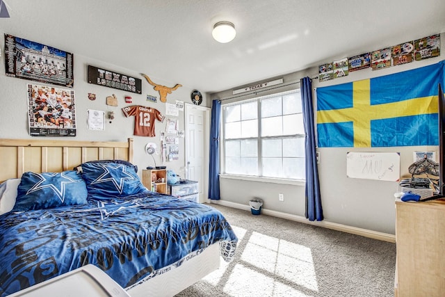 bedroom with a textured ceiling and carpet