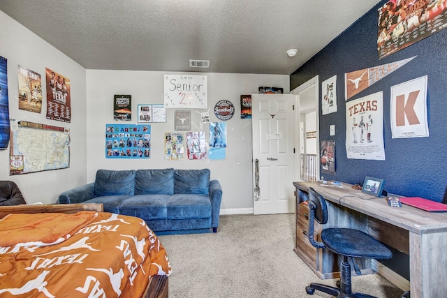 bedroom with carpet and a textured ceiling