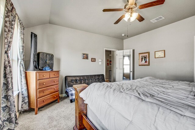 carpeted bedroom with vaulted ceiling and ceiling fan