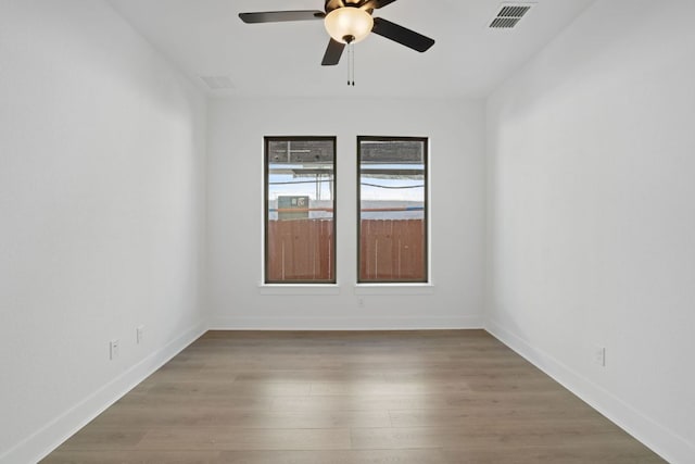 1515 Cardinal Ln, Round Rock, TX 78681 - unfurnished room with ceiling fan, wood finished floors, and baseboards