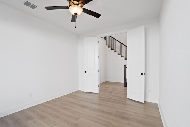 1515 Cardinal Ln, Round Rock, TX 78681 - unfurnished room featuring a ceiling fan, light wood-style floors, and stairway