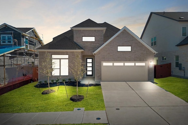 1515 Cardinal Ln, Round Rock, TX 78681 - view of front of property featuring a garage, concrete driveway, a shingled roof, and brick siding