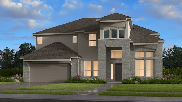 view of front of home featuring a front yard and a garage