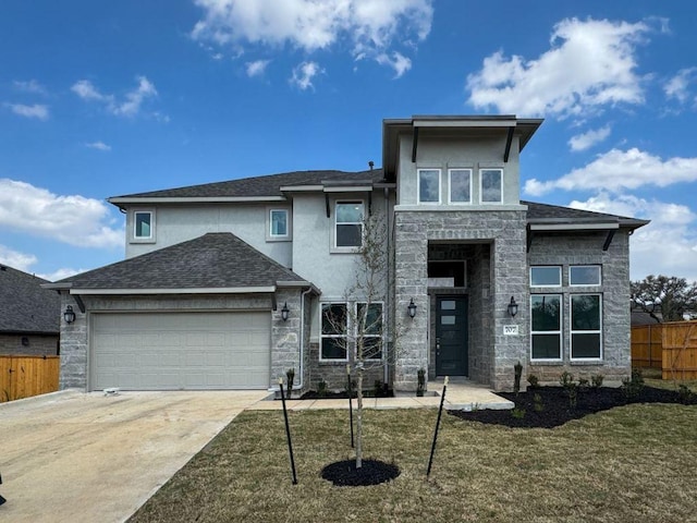 prairie-style house featuring fence, an attached garage, stucco siding, concrete driveway, and stone siding