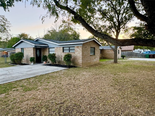 single story home featuring a yard