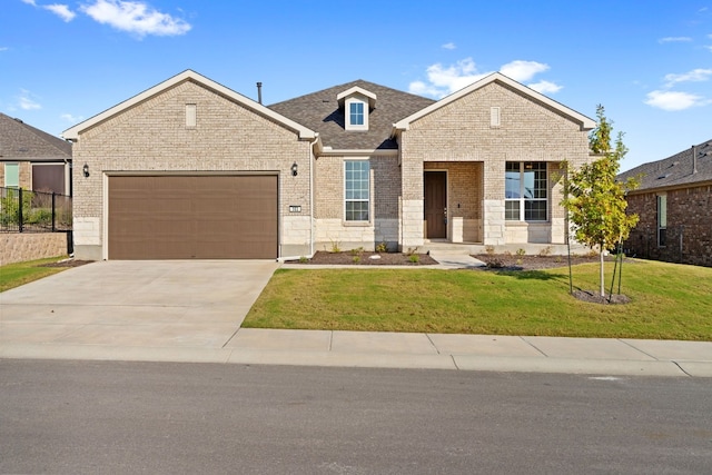 view of front of property featuring a front lawn and a garage