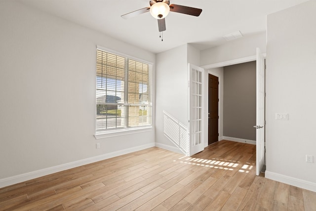 unfurnished room with ceiling fan and light wood-type flooring