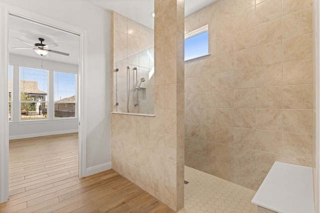 bathroom featuring ceiling fan, hardwood / wood-style flooring, and tiled shower