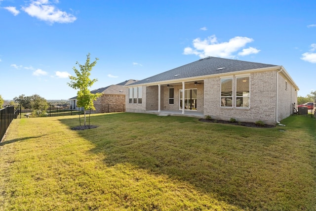 back of house with central AC, a patio area, a lawn, and ceiling fan