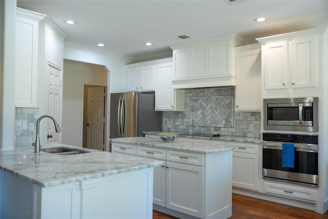 kitchen featuring stainless steel appliances, dark wood-type flooring, light stone counters, sink, and white cabinetry