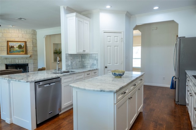 kitchen featuring a center island, white cabinets, sink, and stainless steel appliances