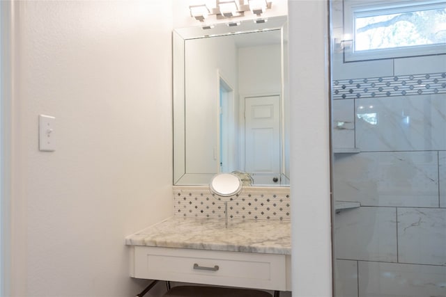 bathroom featuring tasteful backsplash and vanity