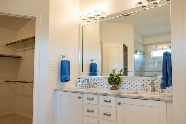 bathroom featuring decorative backsplash, vanity, and vaulted ceiling