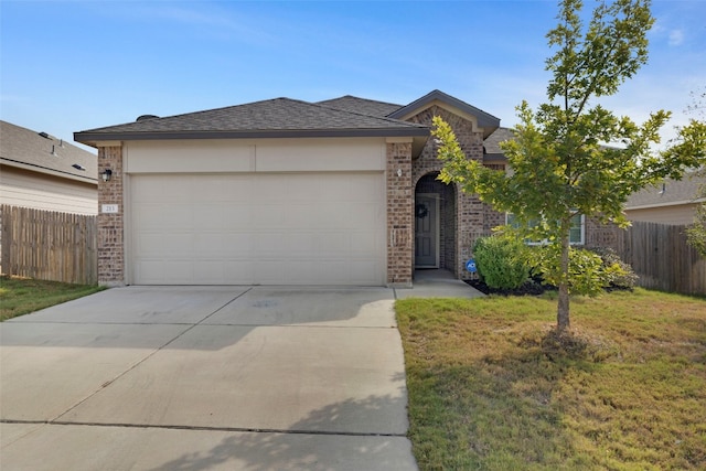 view of front of house featuring a garage and a front yard