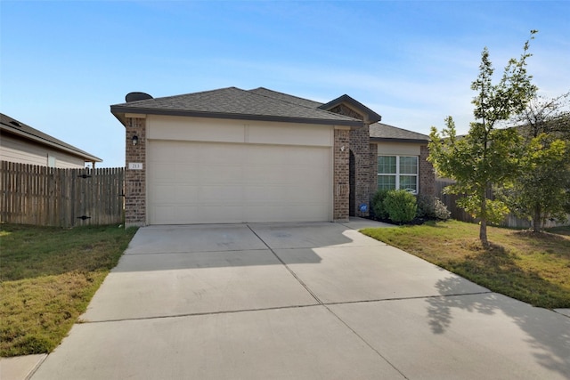 view of front facade with a garage and a front yard