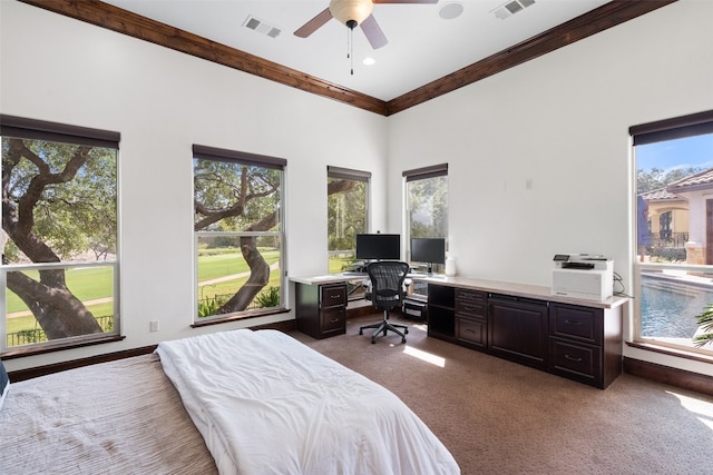 bedroom featuring carpet flooring, ornamental molding, and ceiling fan