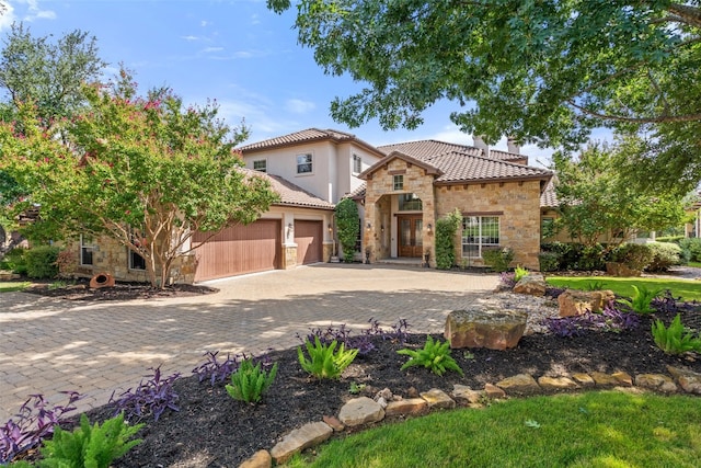 mediterranean / spanish home with a garage