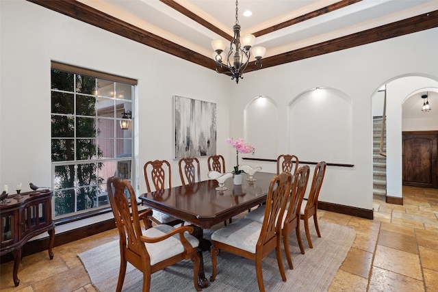 dining space featuring ornamental molding and a notable chandelier