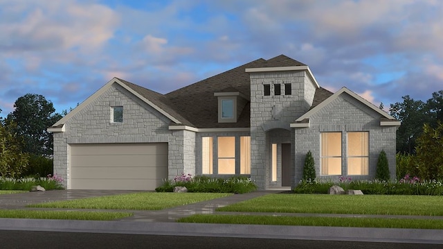 view of front of home featuring a lawn and a garage