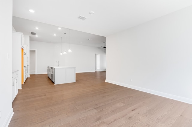 unfurnished living room with light wood-style flooring, recessed lighting, visible vents, and ceiling fan
