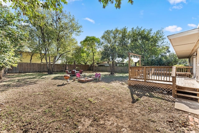 7909 Tisdale Dr, Austin, TX 78757 - fenced backyard with a wooden deck and an outdoor fire pit