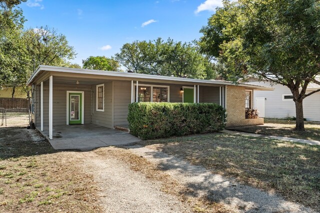 7909 Tisdale Dr, Austin, TX 78757 - ranch-style home with fence, a carport, and dirt driveway