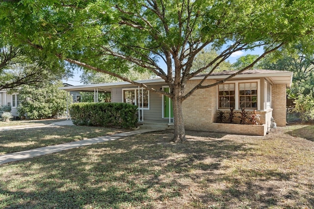 7909 Tisdale Dr, Austin, TX 78757 - view of front of home featuring a front yard, covered porch, and brick siding