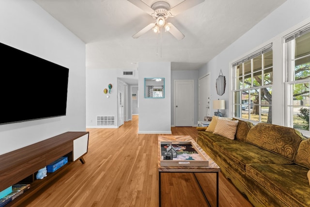 7909 Tisdale Dr, Austin, TX 78757 - living area featuring a ceiling fan, light wood-style floors, and baseboards