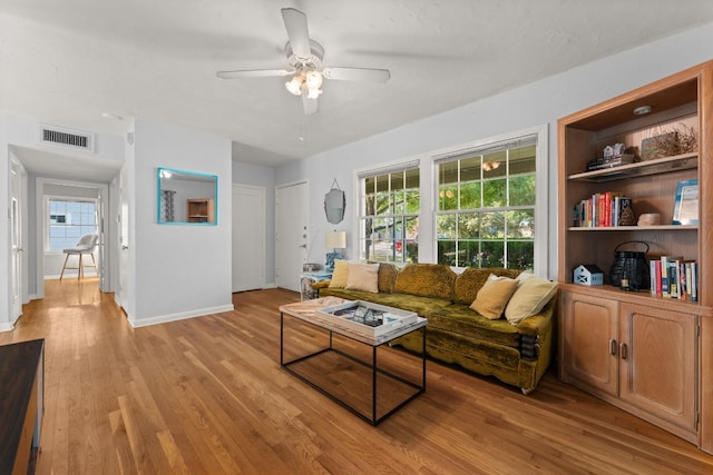 7909 Tisdale Dr, Austin, TX 78757 - living room featuring ceiling fan, light wood-type flooring, baseboards, and healthy amount of natural light