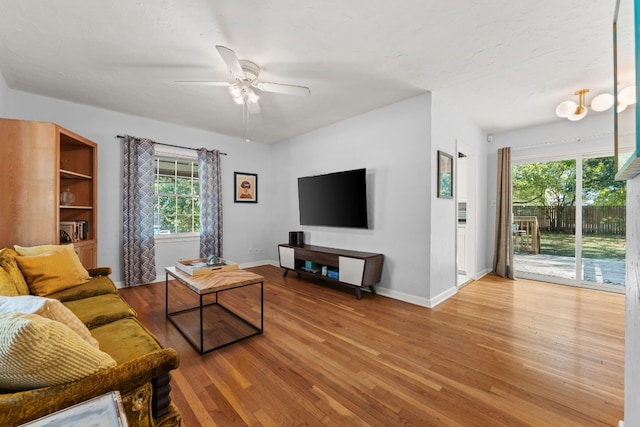 7909 Tisdale Dr, Austin, TX 78757 - living room featuring baseboards, light wood-style flooring, a ceiling fan, and healthy amount of natural light